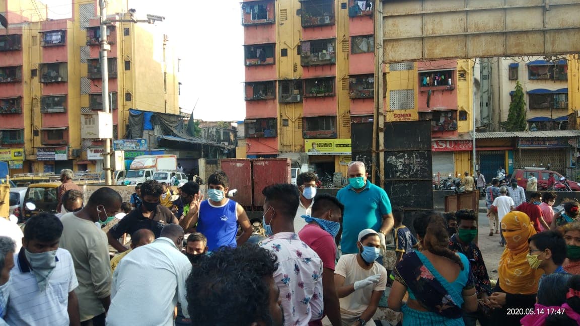 A queue forming along a street outside a camp