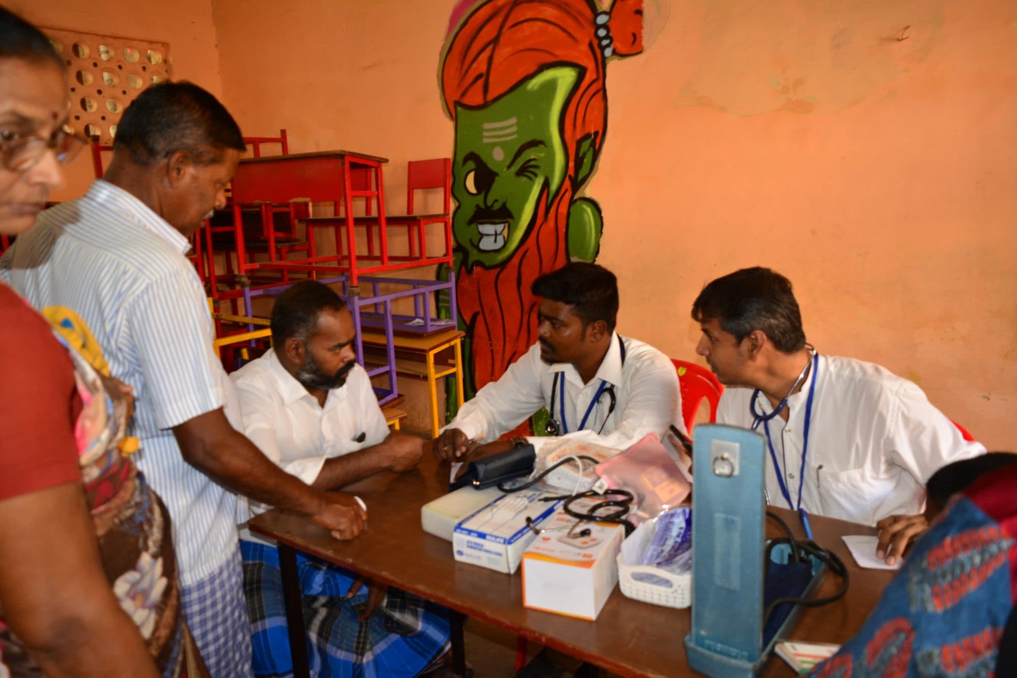 A Foundation clinician examining a patient at a community camp