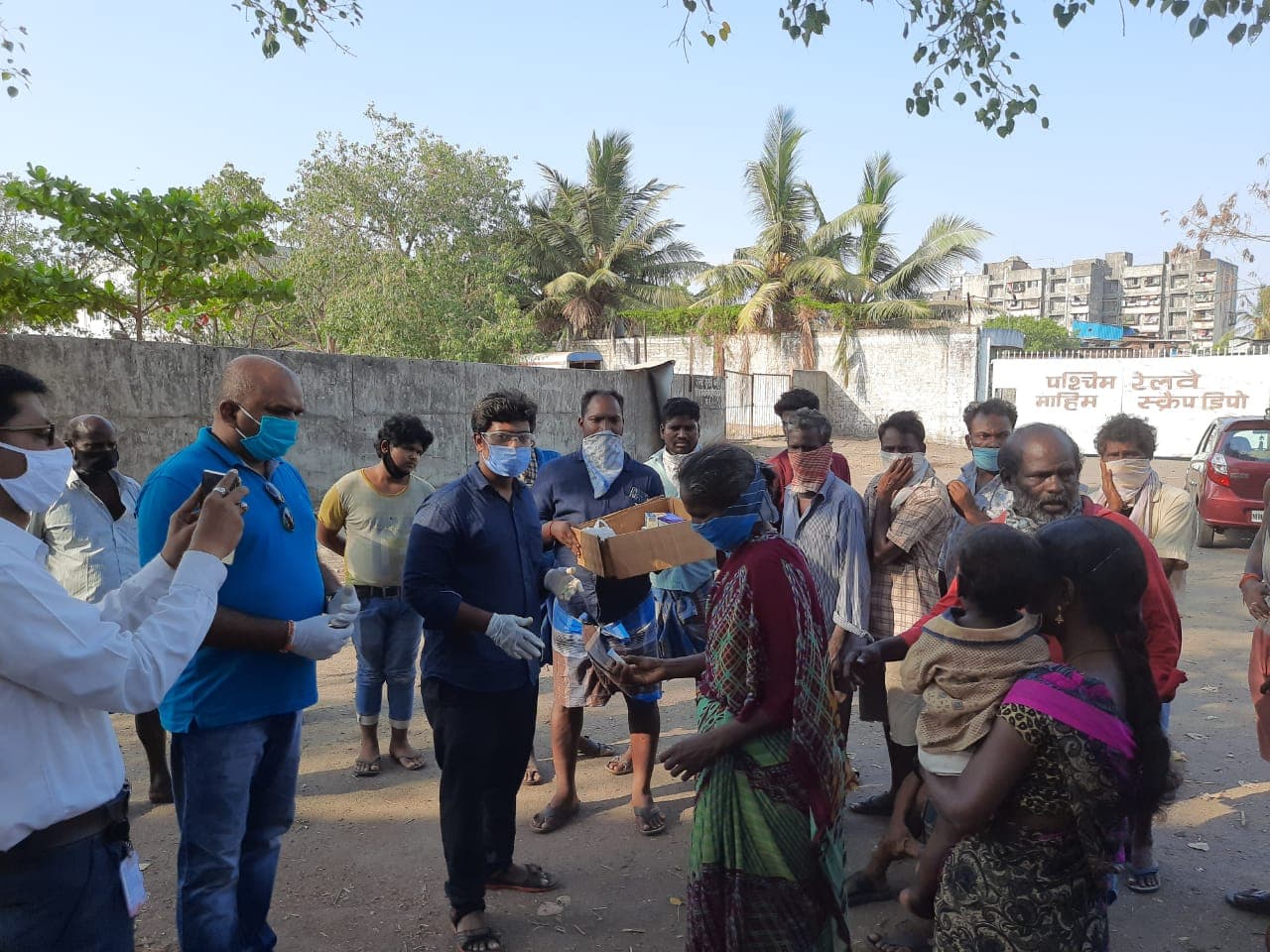 Volunteers distributing supplies to a gathered crowd