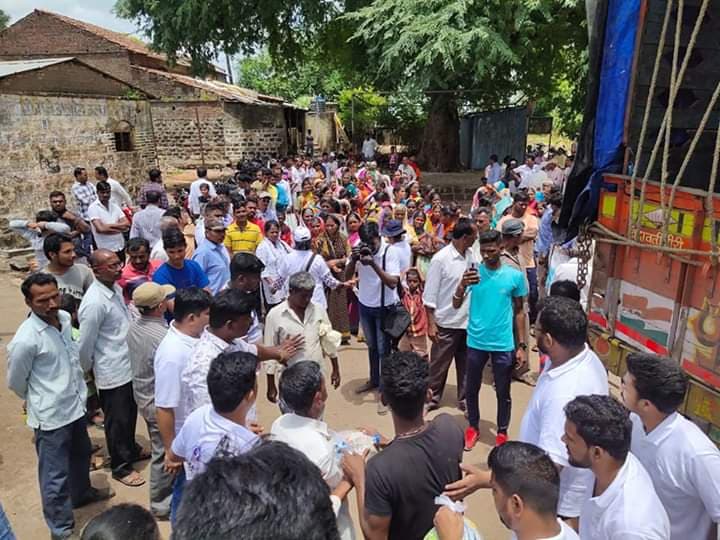 A long line of people waiting at a distribution point